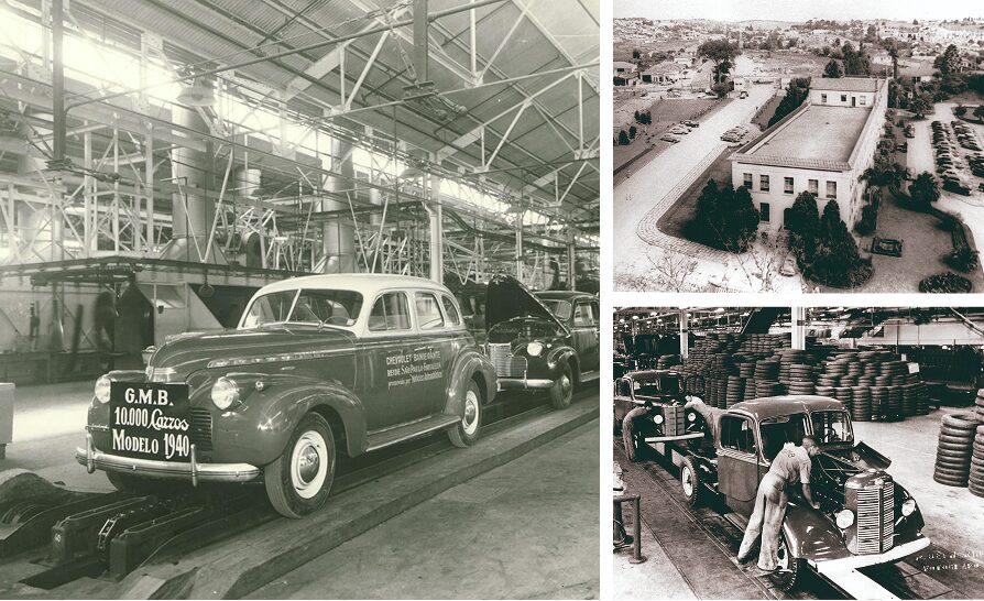 Linha de produção da General Motors em 1940, com automóveis modelo sedã saindo da fábrica. O carro em destaque exibe uma placa escrita G.M.B. 10.000 Carros Modelo 1940, marcando a produção comemorativa e vista aérea histórica da fábrica da General Motors do Brasil, mostrando prédio administrativo cercado por jardins, estacionamentos e ruas internas.