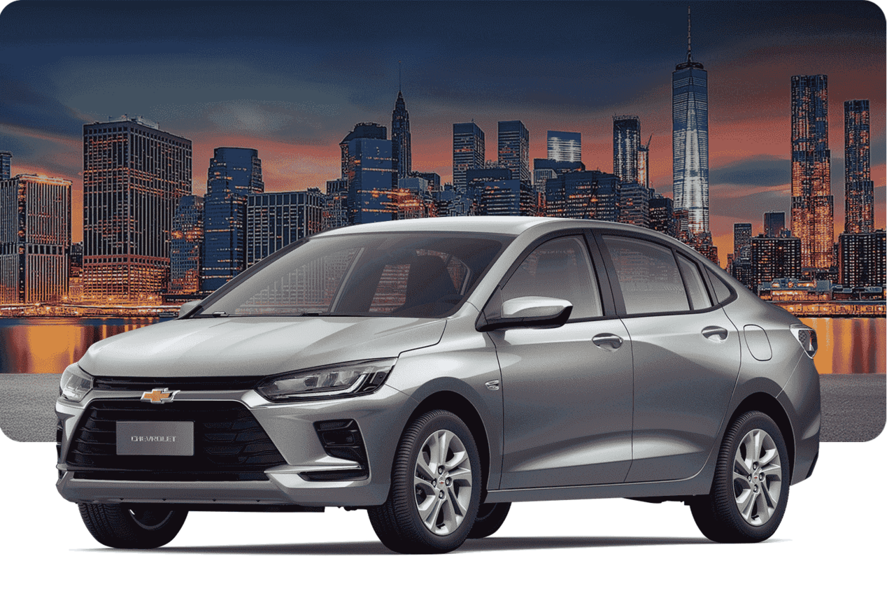 Chevrolet Onix Sedán versión LTZ AT sobre un fondo urbano con edificios al atardecer. 