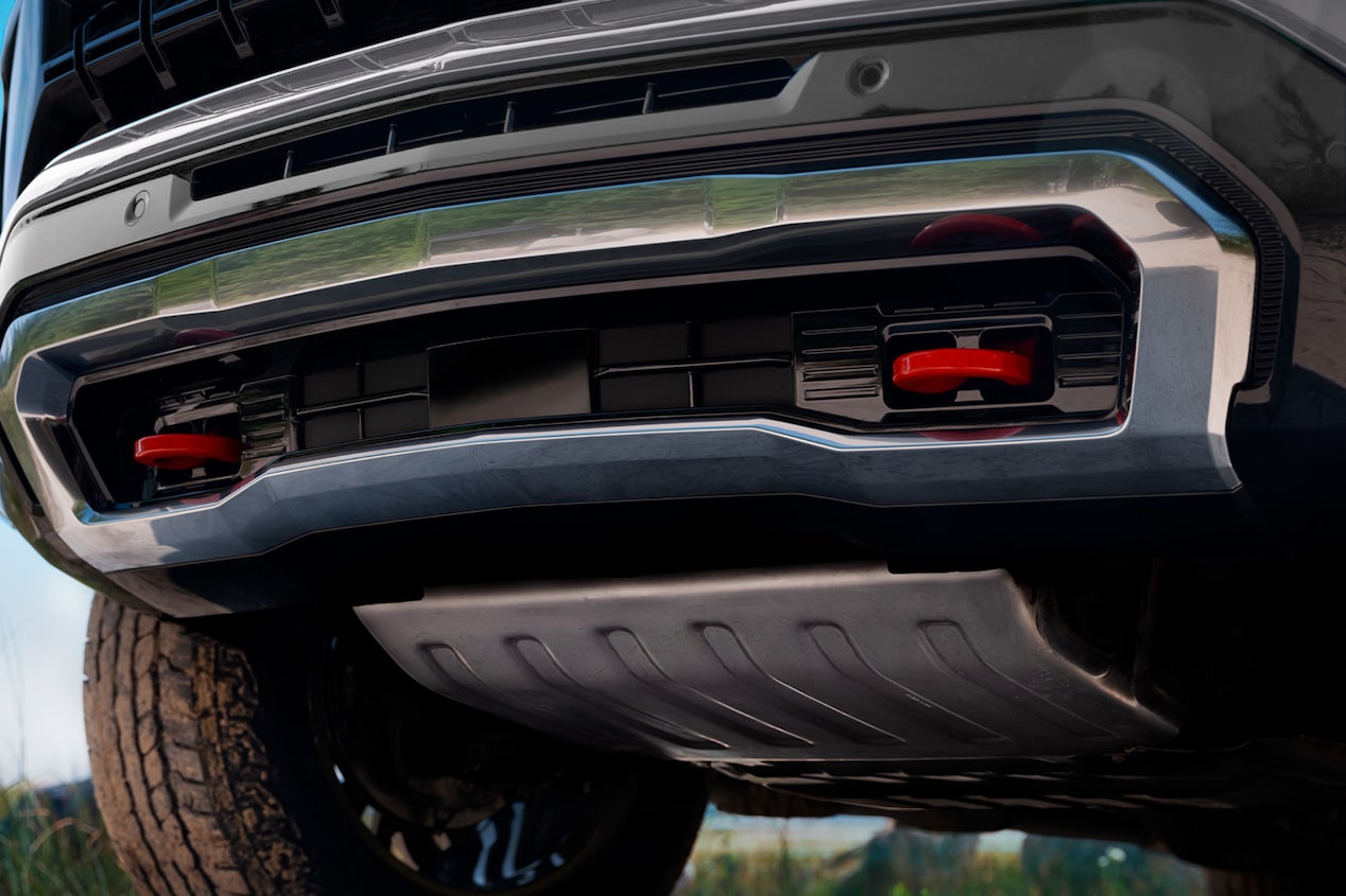 Vista en primer plano de la parte trasera inferior de una Chevrolet Tahoe, mostrando el paragolpes, la protección metálica inferior y detalles del chasis.