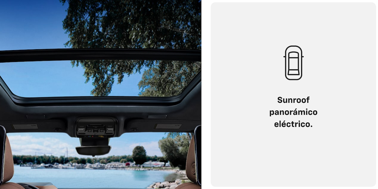 Sunroof panorámico eléctrico de la Chevrolet Suburban Z71 con vista al cielo y los árboles desde el interior del vehículo.